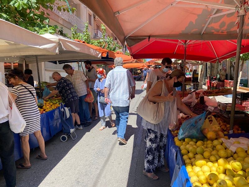 People shopping at a fresh food street market.